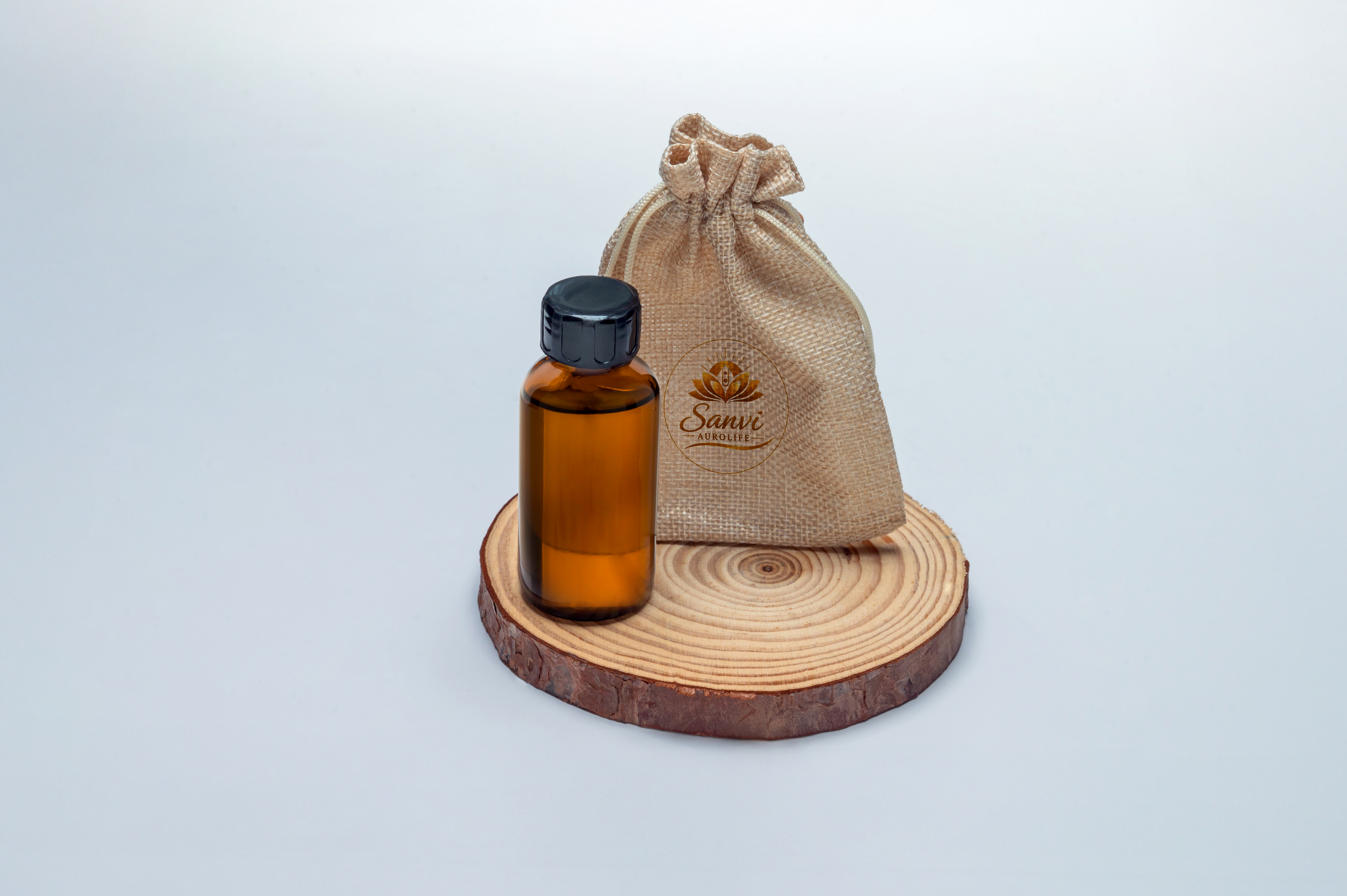 Sandalwood essence oil in amber bottle with jute pouch